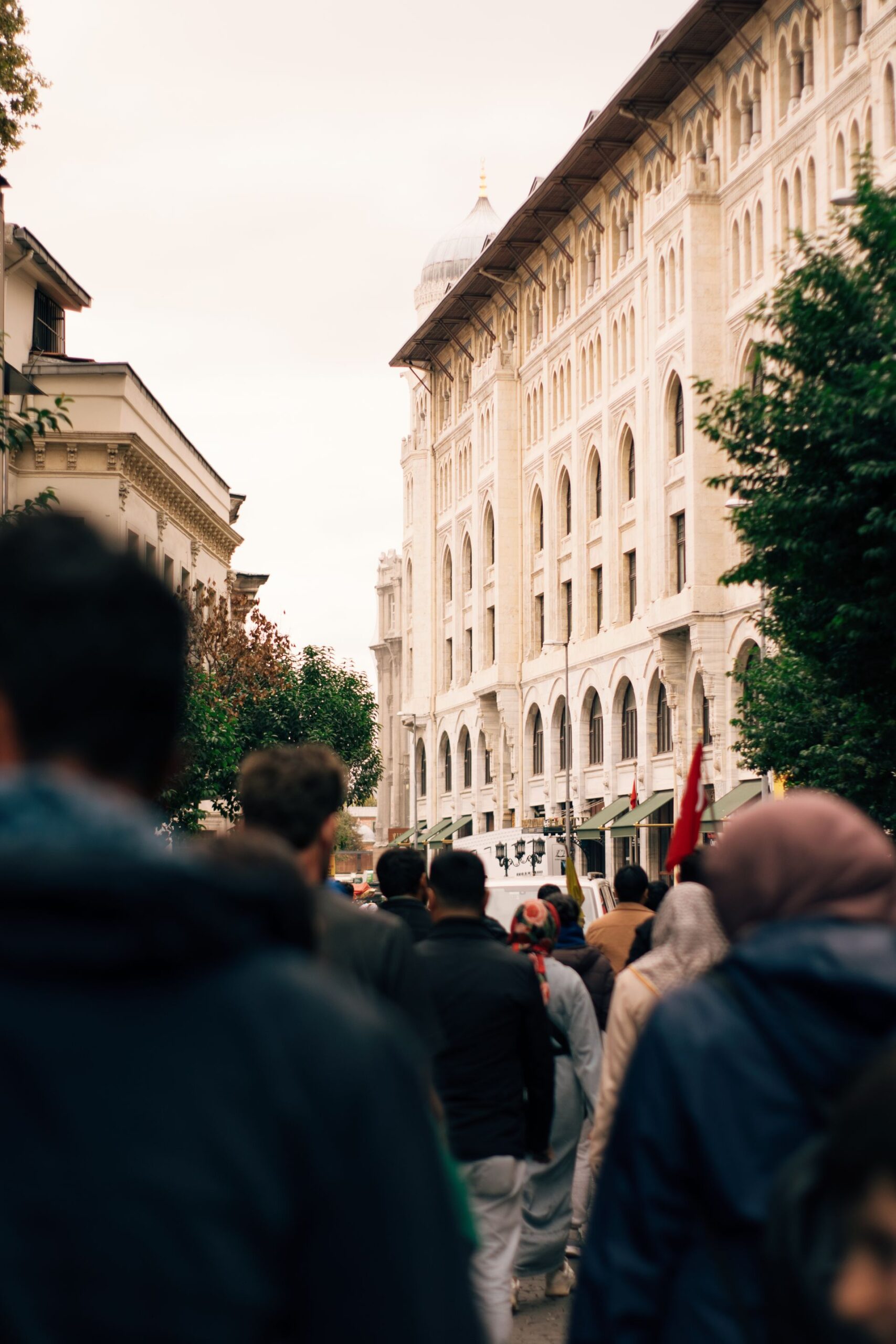 Large crowd walking through a historic city street
