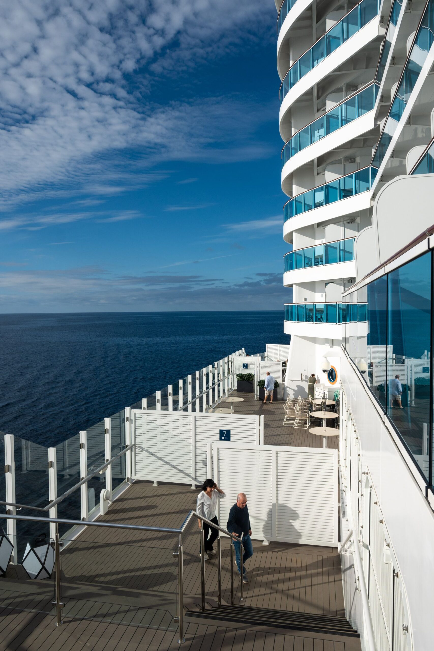 Passengers enjoying a sunny day on a cruise ship deck