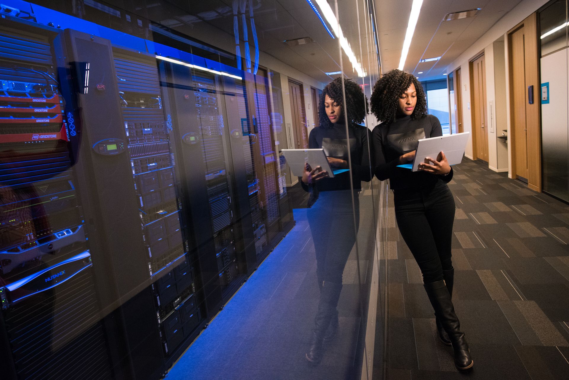 Engineer with laptop working in a modern data center