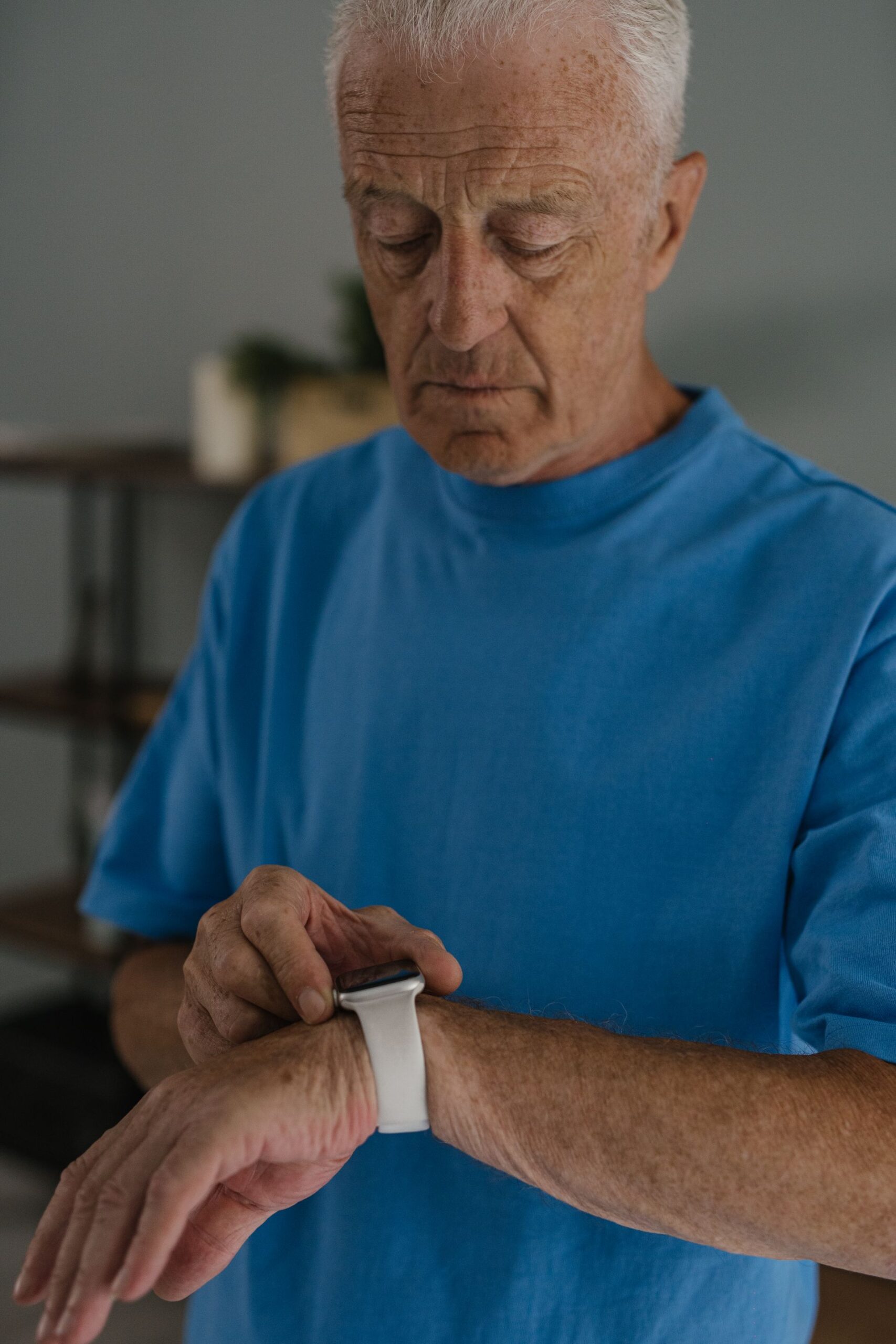 Elderly man adjusting his smartwatch