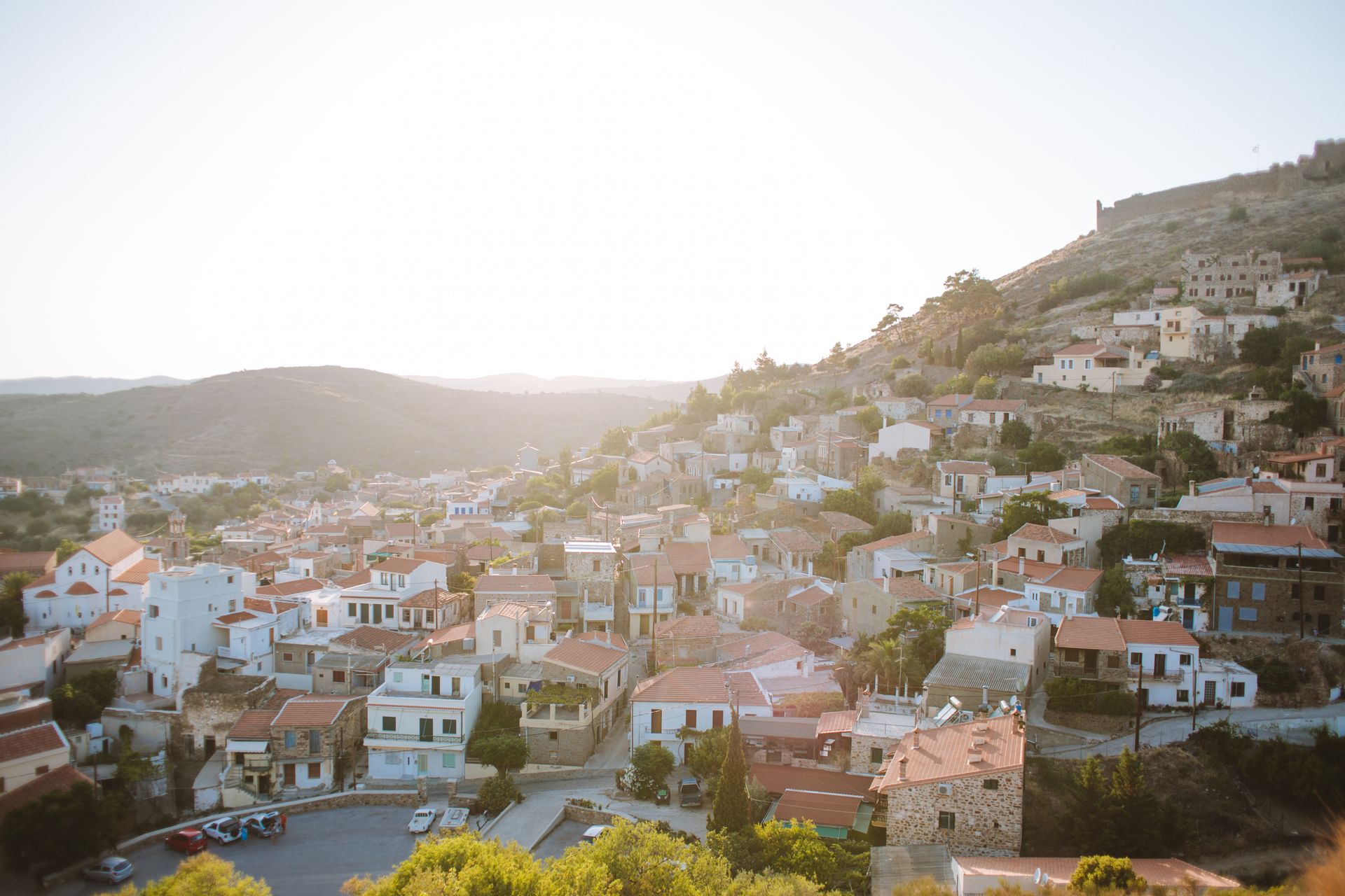 Aerial view of a traditional Greek hillside town at sunset