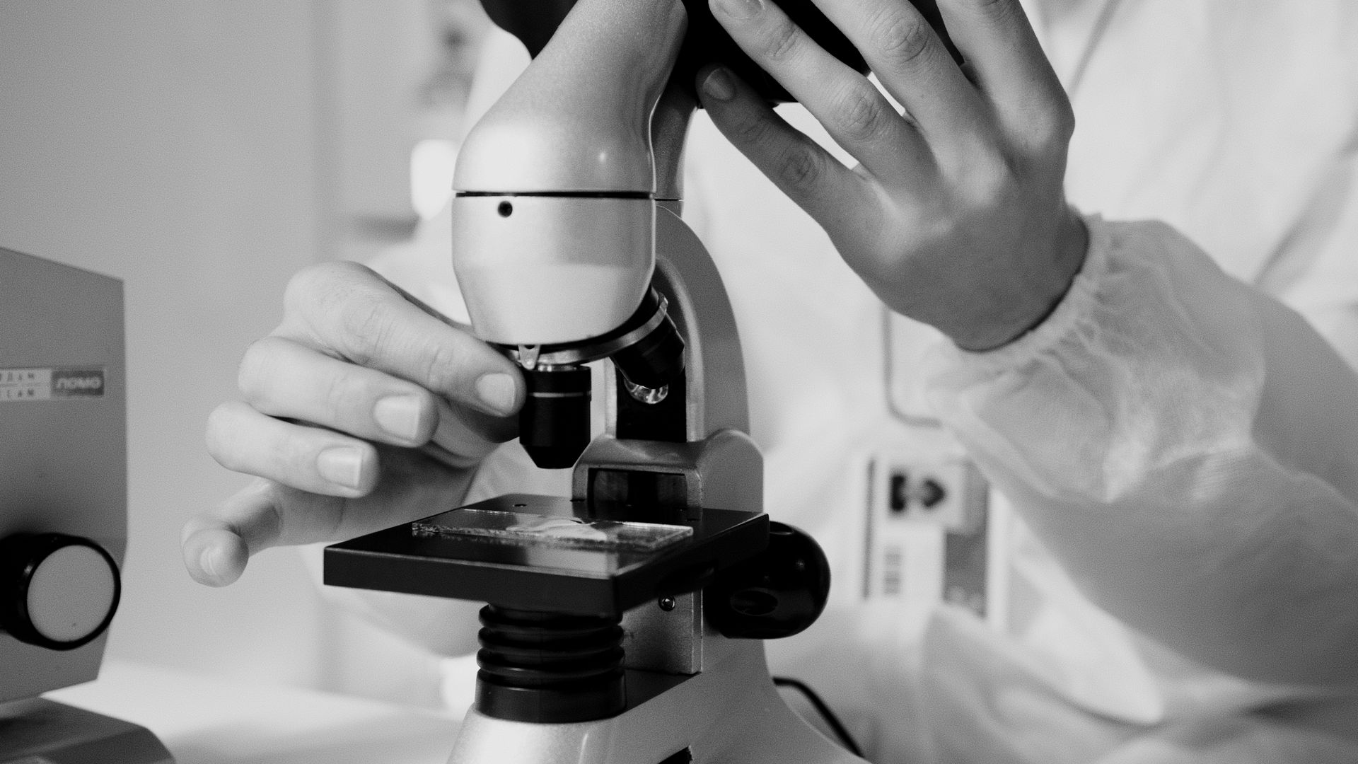 Researcher using a microscope in a laboratory