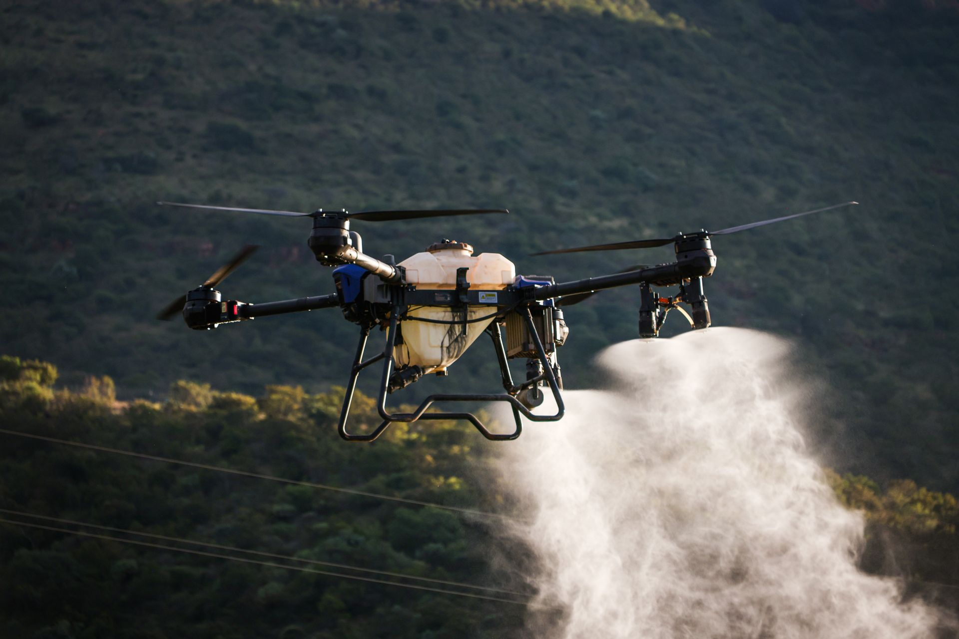 Drone spraying crops with precision agriculture technology