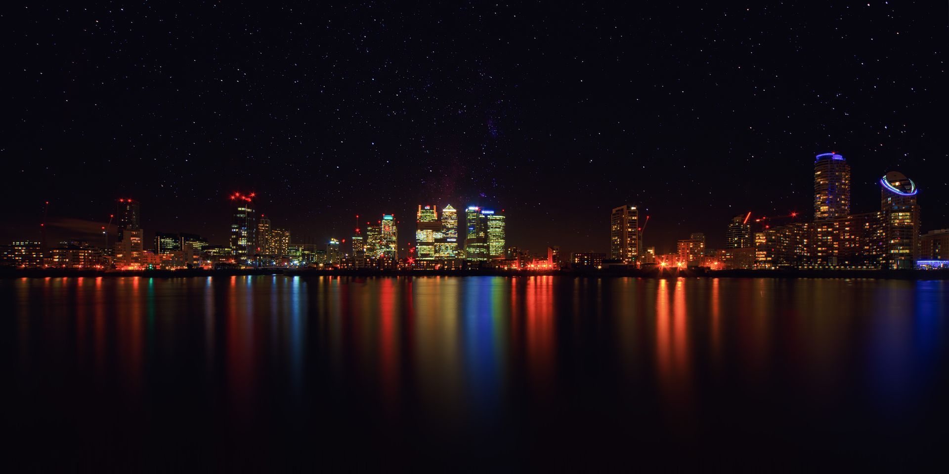 Skyline of a modern city with illuminated buildings at night